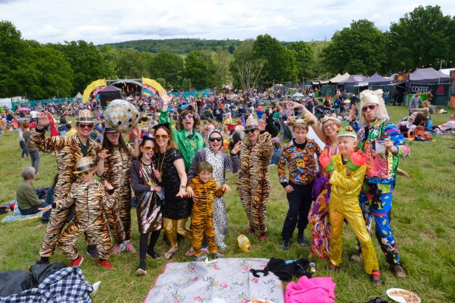 Families in fancy dress at Elderflower Fields Festival near Brighton. 